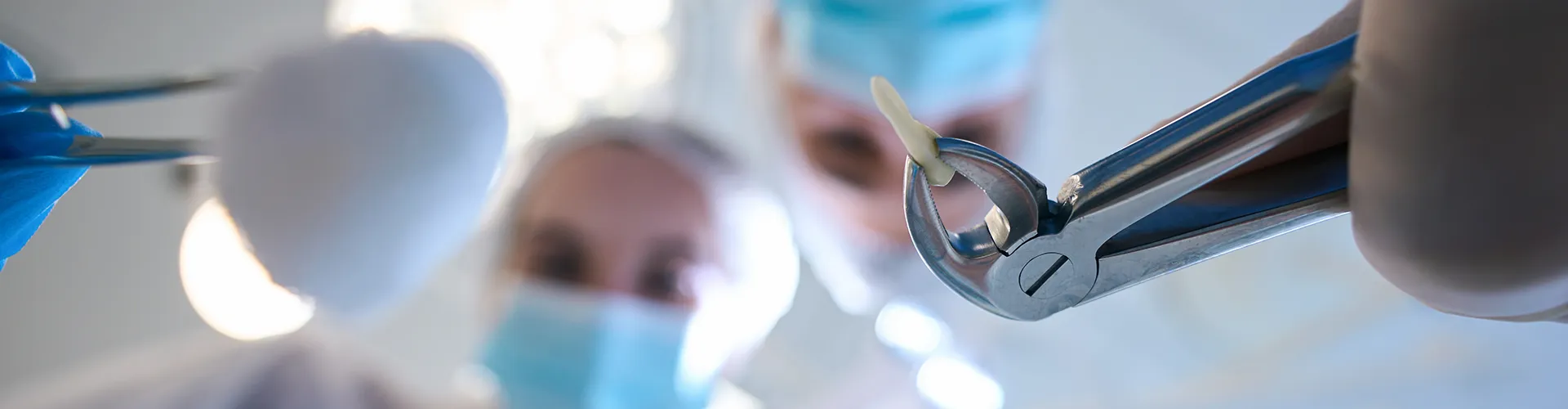 blurry image of two people in masks looking down